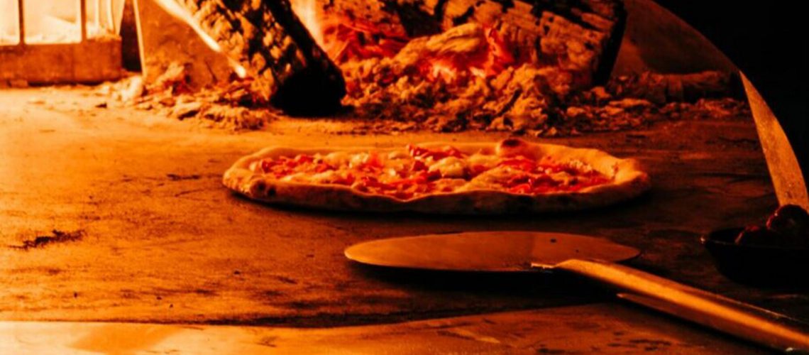 Savor the Aroma of Freshly Baked Pizza: A Culinary Delight Close to Food Hall Markets.